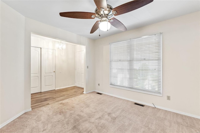 unfurnished bedroom with ceiling fan, a closet, and light colored carpet