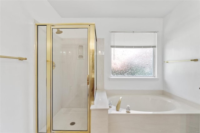 bathroom featuring separate shower and tub