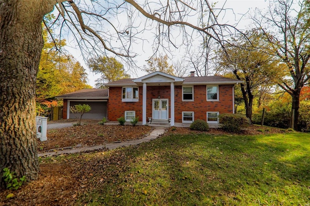 split foyer home with a front yard and a garage