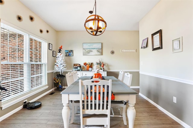 dining room with a notable chandelier and hardwood / wood-style floors