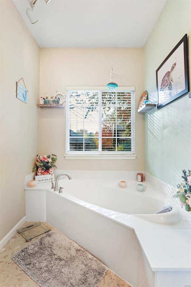 bathroom featuring a bath and tile patterned flooring