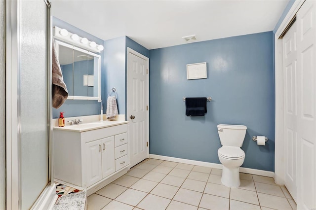 bathroom featuring a shower with door, vanity, toilet, and tile patterned flooring