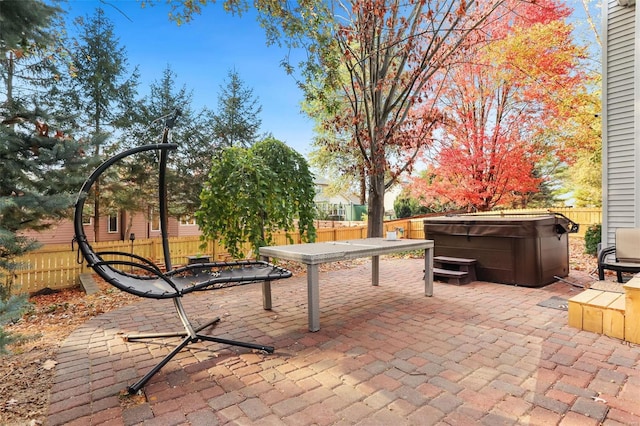 view of patio / terrace with a hot tub