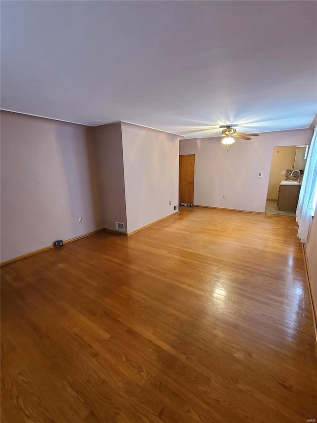 unfurnished room with ceiling fan and light hardwood / wood-style flooring