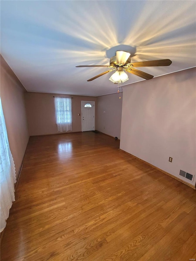 unfurnished room with ceiling fan and light hardwood / wood-style flooring