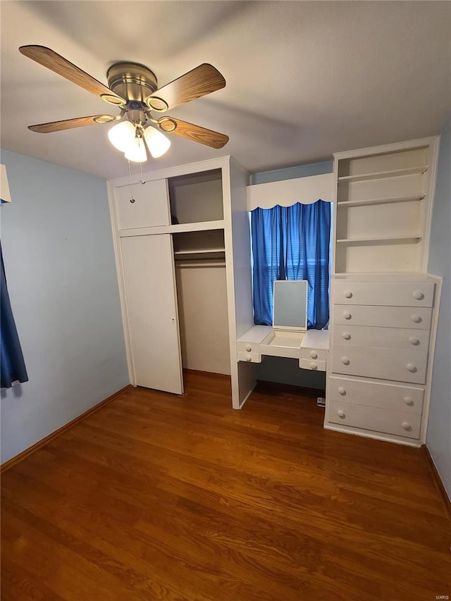 unfurnished bedroom featuring ceiling fan, dark hardwood / wood-style flooring, and a closet