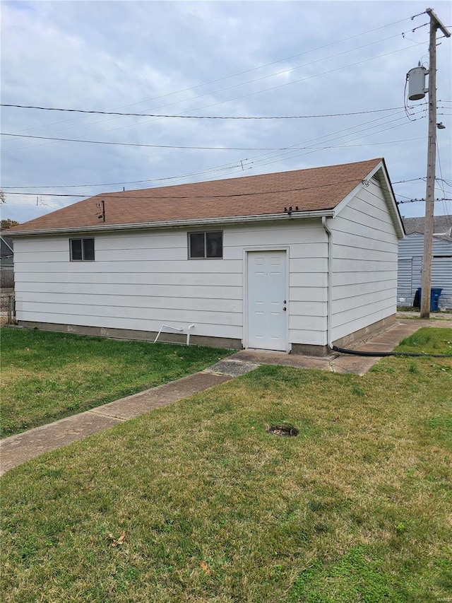 rear view of property with a lawn