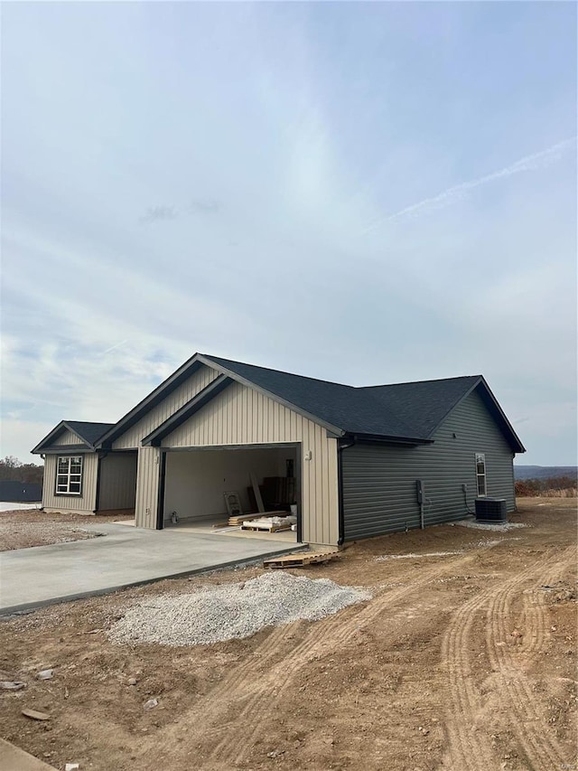 view of home's exterior with a garage and central air condition unit