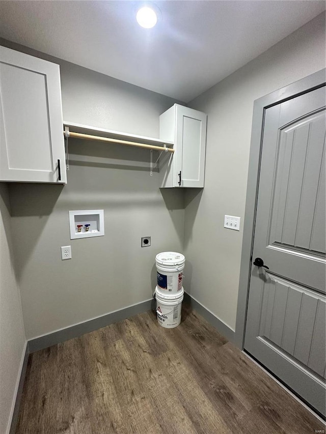 laundry area featuring dark wood-style floors, washer hookup, cabinet space, electric dryer hookup, and baseboards