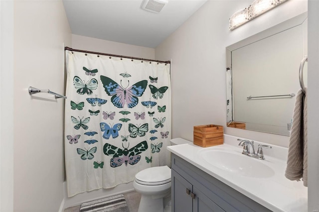 bathroom with vanity, toilet, and walk in shower