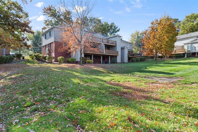 rear view of house featuring a lawn