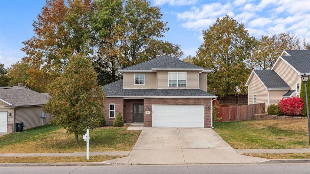 view of property featuring a garage and a front lawn