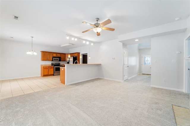 unfurnished living room with light tile patterned floors, ceiling fan with notable chandelier, and rail lighting