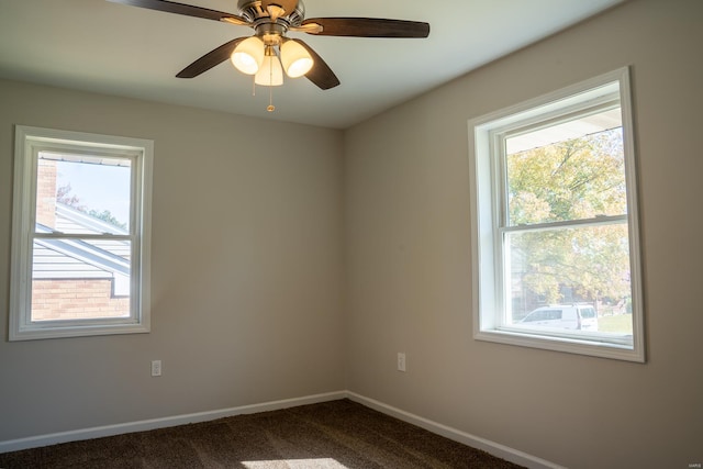 spare room with carpet floors, a healthy amount of sunlight, and ceiling fan