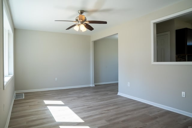 spare room with ceiling fan and light wood-type flooring