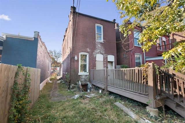 rear view of house featuring a deck