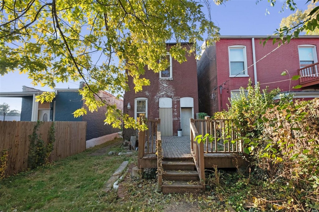 rear view of property with a wooden deck