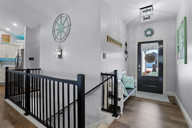 entryway featuring dark hardwood / wood-style floors and vaulted ceiling