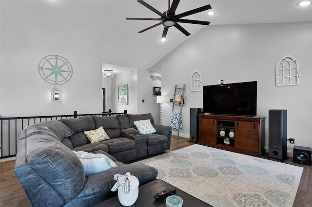 living room featuring dark hardwood / wood-style floors, high vaulted ceiling, and ceiling fan