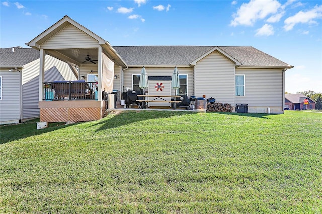 rear view of property with a yard, a patio, and ceiling fan