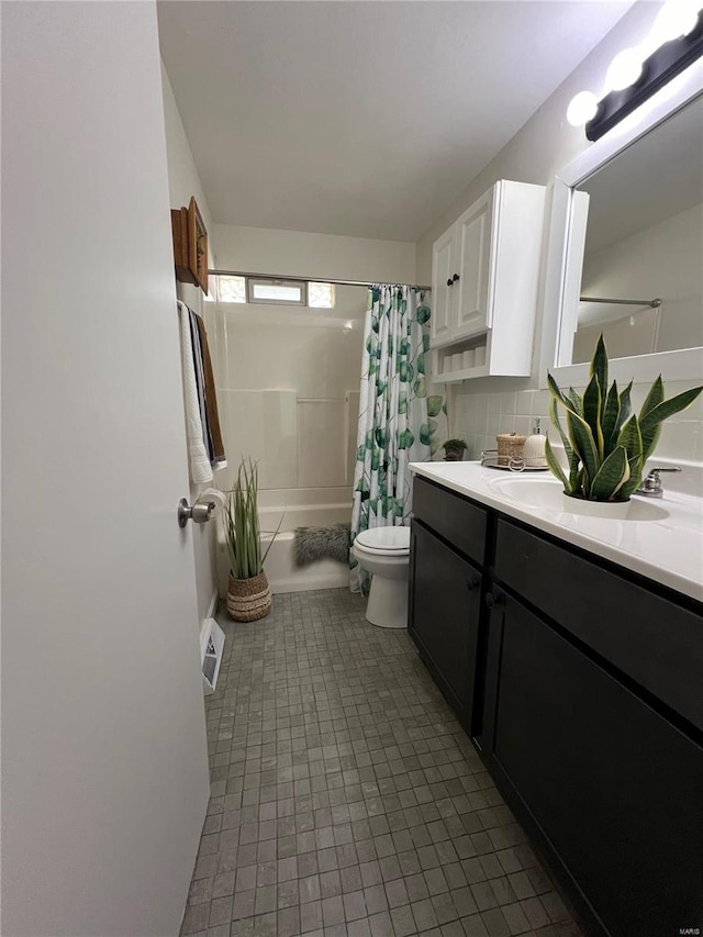 full bathroom featuring shower / tub combo, tasteful backsplash, toilet, tile patterned floors, and vanity