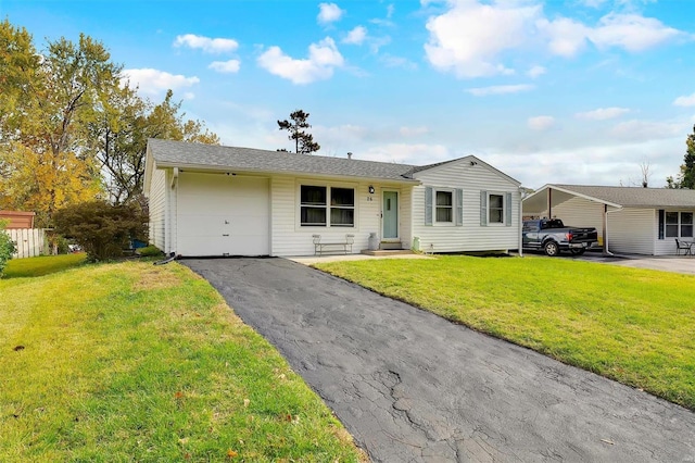 ranch-style house with a garage, a front lawn, and a carport