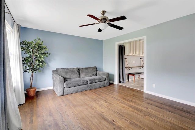 living room with hardwood / wood-style floors and ceiling fan