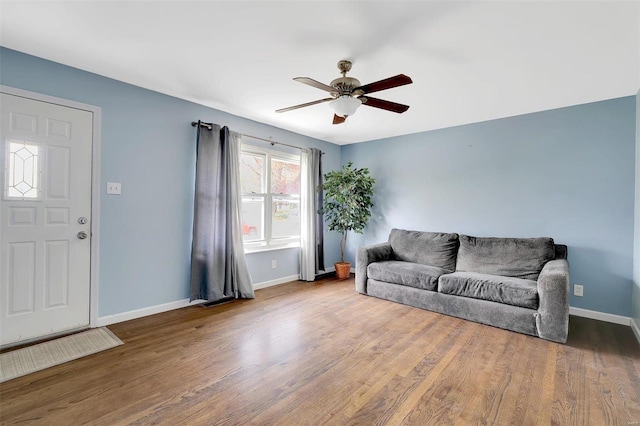 living room featuring hardwood / wood-style flooring and ceiling fan