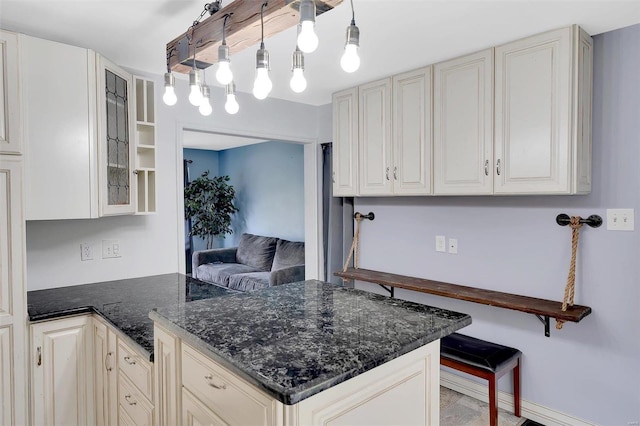 kitchen with pendant lighting and dark stone countertops