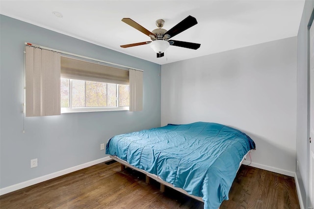 bedroom with dark wood-type flooring and ceiling fan