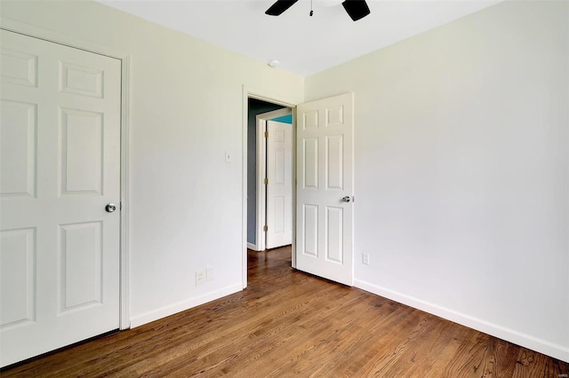 unfurnished bedroom featuring hardwood / wood-style floors and ceiling fan