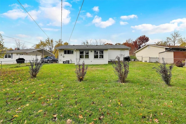 rear view of house featuring a lawn