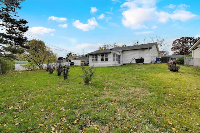 rear view of property with a yard