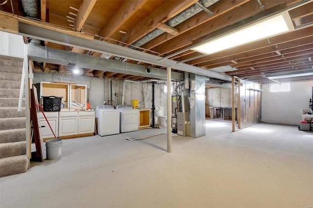 basement with washer and clothes dryer and heating unit