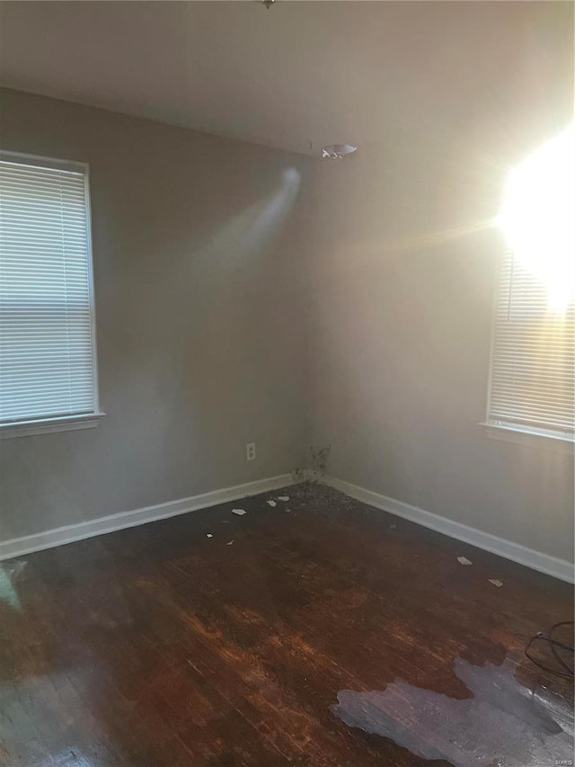 spare room with dark wood-type flooring