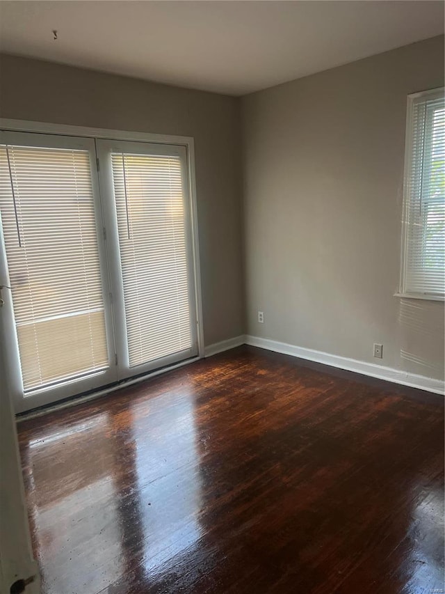 empty room with dark hardwood / wood-style floors