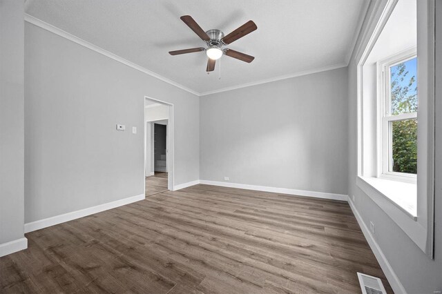 unfurnished room with ceiling fan, hardwood / wood-style flooring, and crown molding