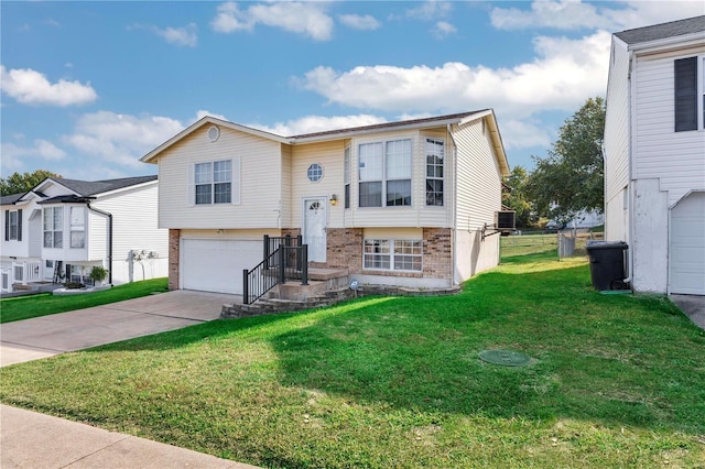 bi-level home with a front lawn, central AC unit, and a garage