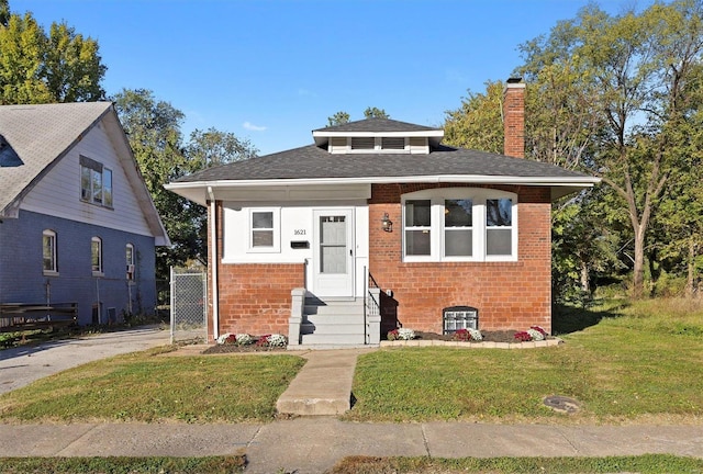 bungalow-style home with a front lawn