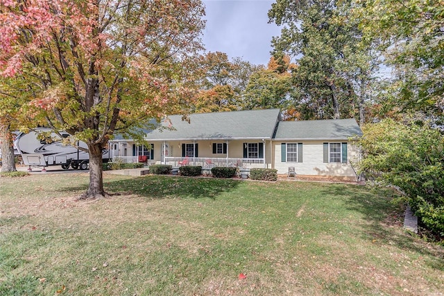 ranch-style home with covered porch and a front yard