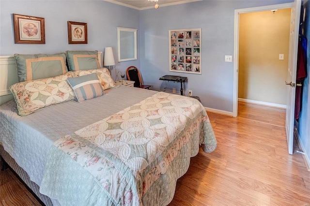 bedroom with light wood-type flooring and ornamental molding