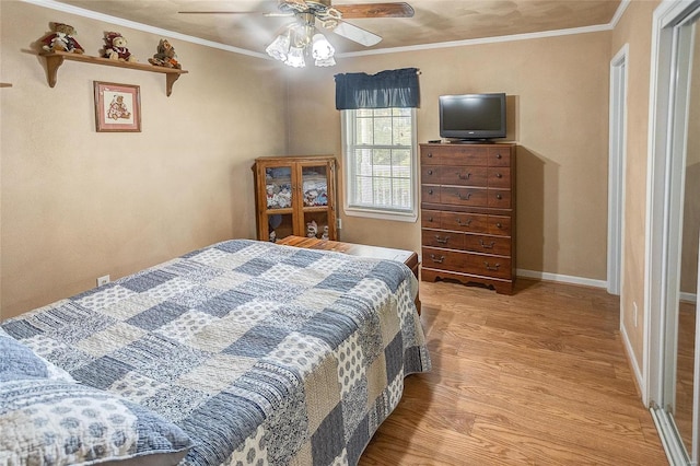 bedroom featuring ceiling fan, crown molding, and light wood-type flooring