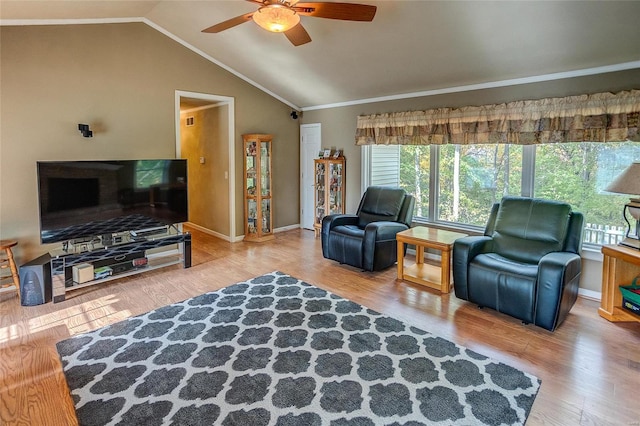 living room with vaulted ceiling, ceiling fan, crown molding, and hardwood / wood-style flooring