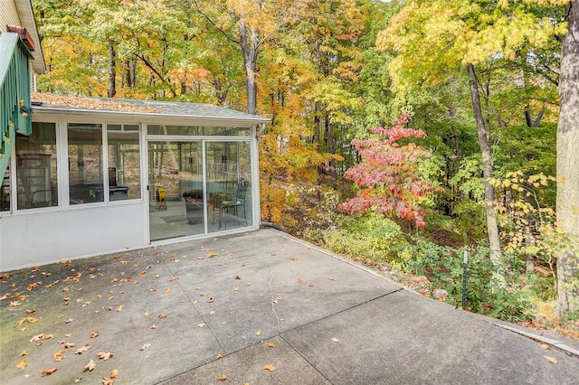 view of patio / terrace featuring a sunroom