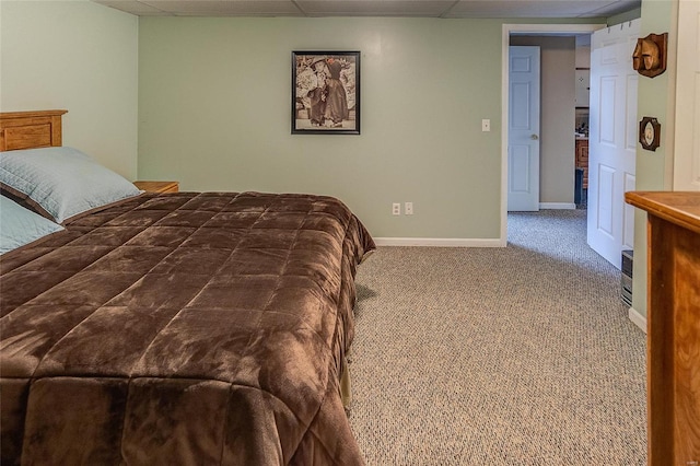 carpeted bedroom featuring a paneled ceiling