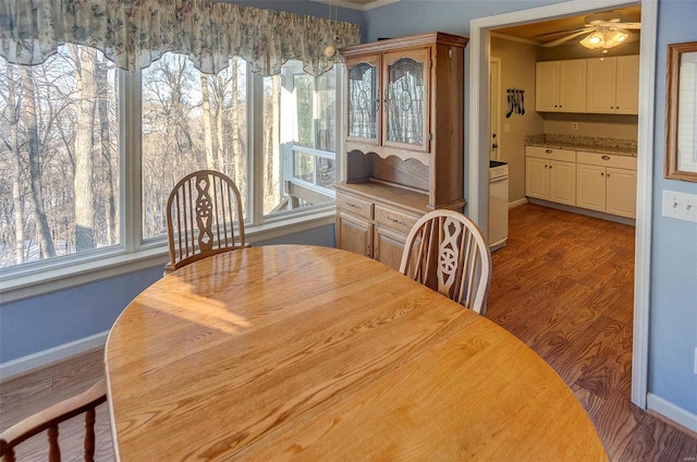 dining space featuring ceiling fan, hardwood / wood-style floors, and ornamental molding