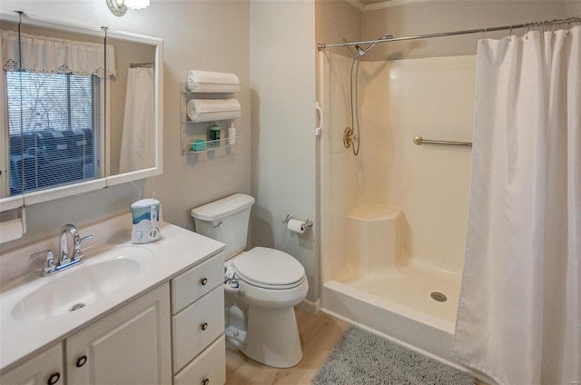 bathroom featuring curtained shower, hardwood / wood-style floors, toilet, and vanity