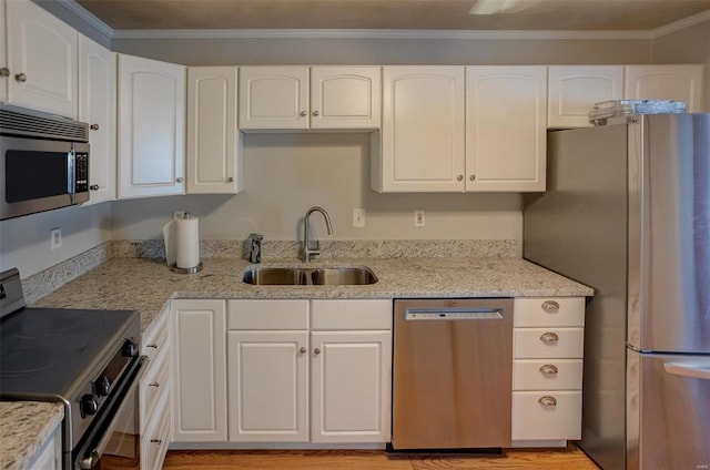 kitchen with white cabinets, appliances with stainless steel finishes, and sink