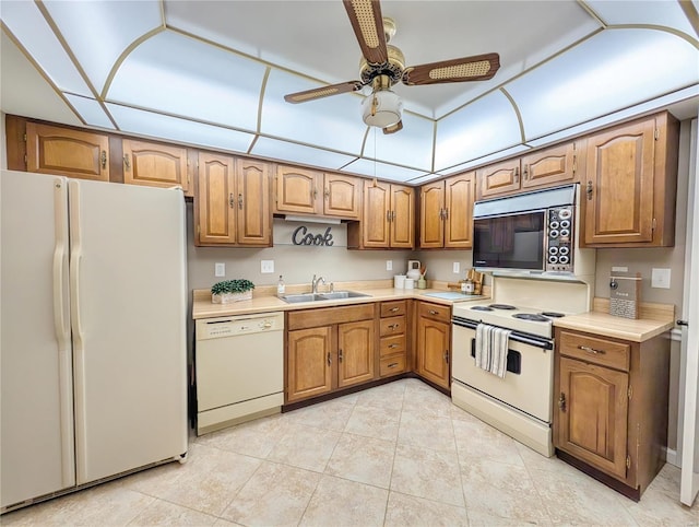 kitchen with sink, light tile patterned flooring, white appliances, and ceiling fan