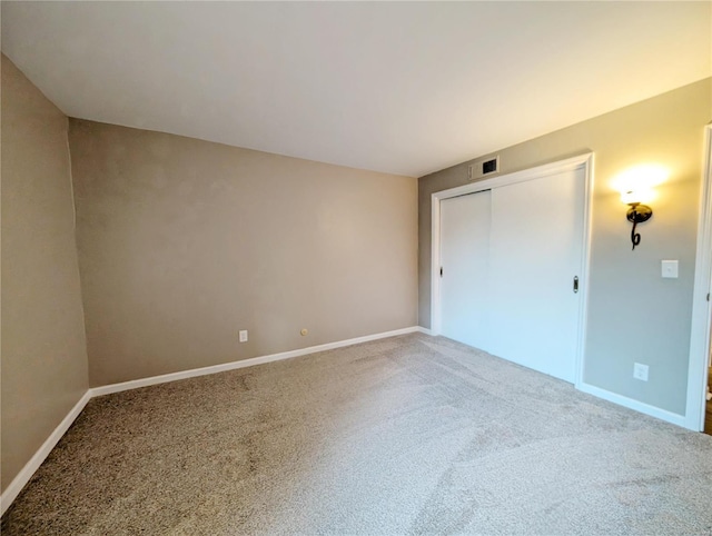 unfurnished bedroom featuring a closet and carpet